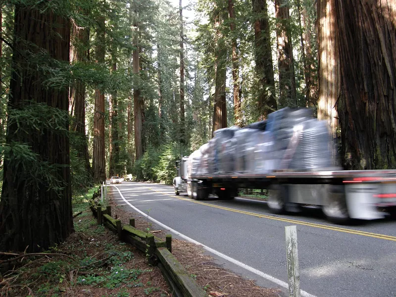 A truck barely stays inside the line while rounding the curve between mile post markers 1.35 and 1.40. The area on the right is where Caltrans proposes a “sliver fill.” - PHOTO BY DAVID BERGIN