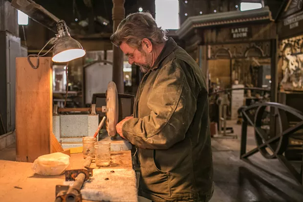 Eric Hollenbeck polishing a black onyx cabochon. - PHOTO BY ALEXANDER WOODARD
