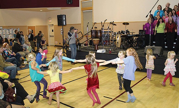 Girls dance a circle dance to music by the Arcata Interfaith Gospel Choir at the annual Bowl of Beans dinner in honor of Martin Luther King Jr. - PHOTO BY BOB DORAN