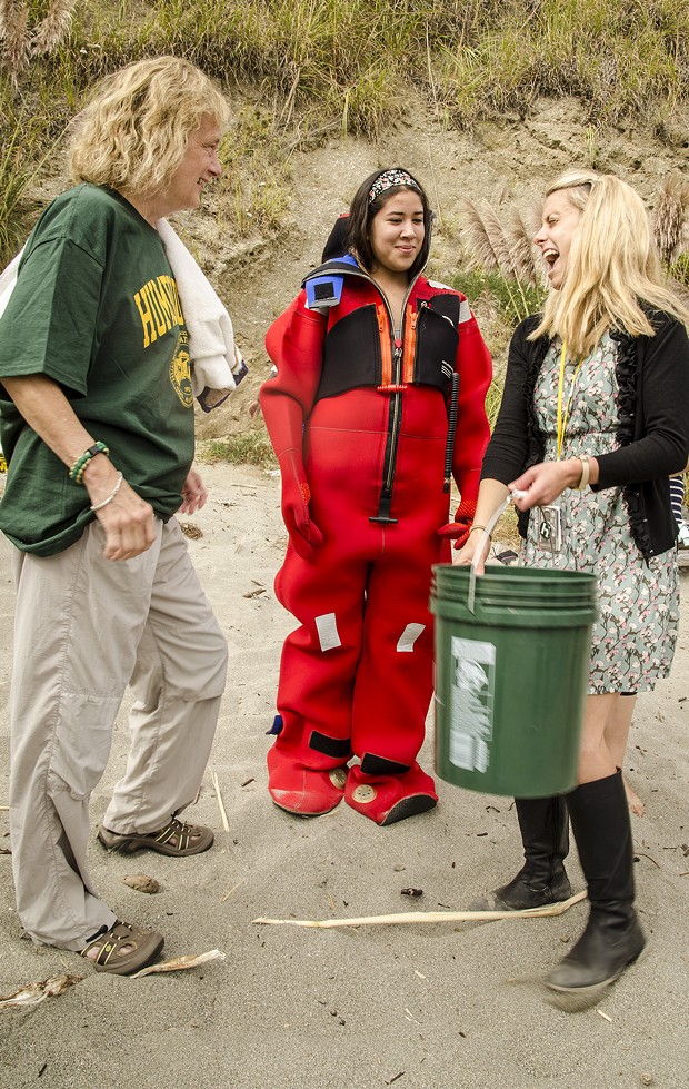HSU President Lisa Rossbacher, freshman Veronica Rivera (in a dry suit) and campus staffer Courtney Haroldson discuss preparations for the "sustainable" Ice-Bucket Challenge. - MARK LARSON PHOTOGRAPHY