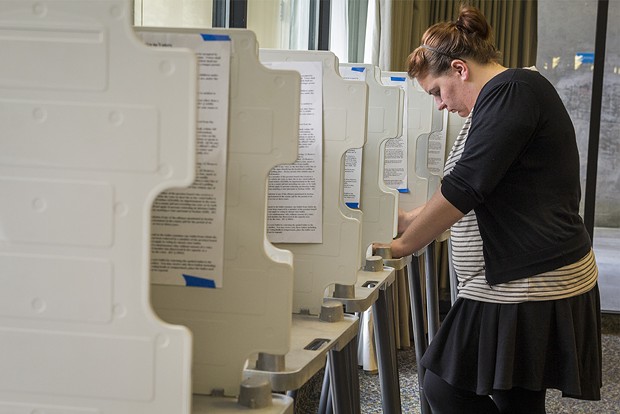 Samantha Boyd studies the voting catalog before casting her ballot at HSU. - MANUEL J. ORBEGOZO