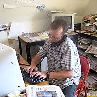 Jack Durham working on his computer at 'The McKinleyville Press.' Photo by Meghannraye Sutton.