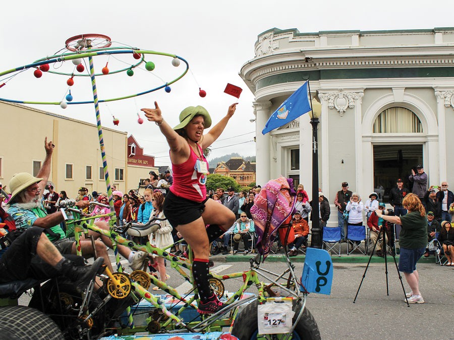 Jerri Wagner joyously crosses the finish line of the 46th annual Kinetic Grand Championship on the rolling, spinning sculpture "Up!" The 42-mile Memorial Day weekend trek concluded on Ferndale's Main Street on Monday, May 27. - PHOTO BY BOB DORAN