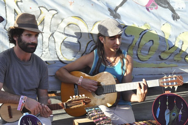 Local crafts people start an impromptu jam session while trying to stay cool at Summer Arts in Benbow. - ©TRAVIS TURNER