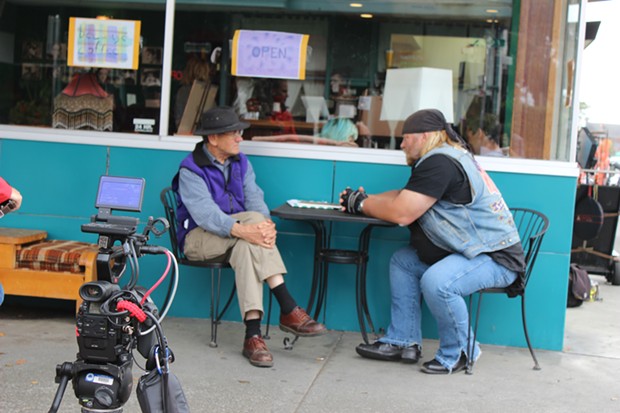 Local historian Ray Hillman (left) speaks with Stan Ellsworth for an upcoming episode of American Ride as a film crew looks on in Old Town Eureka. - THADEUS GREENSON