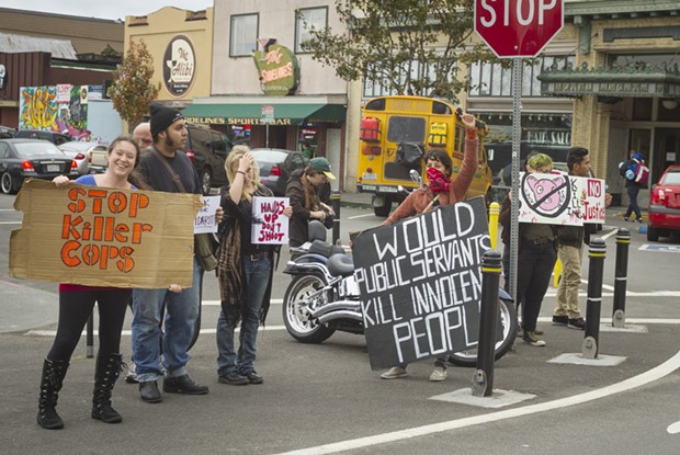 Protesters wave signs at the intersection of Ninth and G streets in Arcata on Oct. 18. - PATRICK EVANS