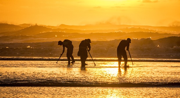 Clam Beach featured a very low tide and a beautiful sunset, plus lots of clam diggers looking for the elusive but very tasty razor clam on Tuesday, Jan. 20. Using a long telephoto lens compressed the distance between the surf line and those looking for clams. - MARK LARSON
