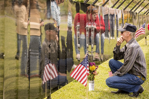 Vietnam veteran Darryl Whiteaker, of Willow Creek, paused to find names of comrades on the replica Wall on Friday.  "I experienced two Tet offenses," he said. "One was enough." He served there in 1967 and 1968. - MARK LARSON