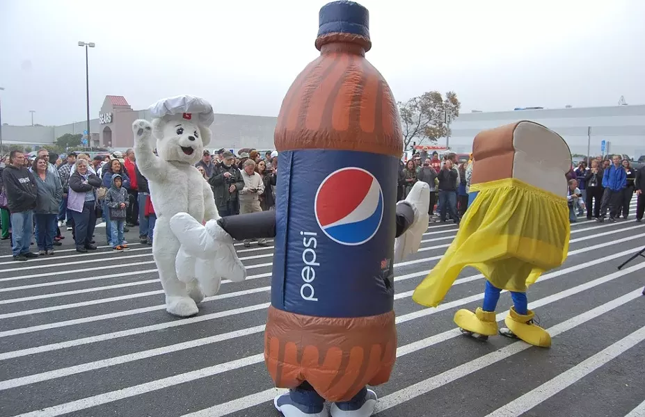 No one’s happier about the new wal-mart than bimbo bear, this walking pepsi bottle and ... is that bread wearing a skirt? - PHOTO BY ANDREW GOFF