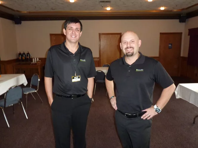 Ohio Valley Gold and Silver Refinery's Dustin Barton (left) and Nate Shaffer set up with most of their gear at the Best Western Bayshore Inn. - PHOTO BY HANK SIMS
