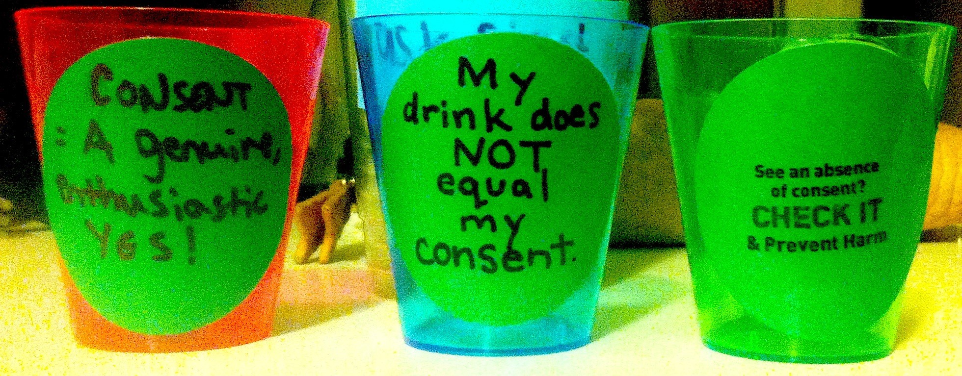Shot glasses displaying pro-consent slogans. - CHECK IT'S FACEBOOK PAGE