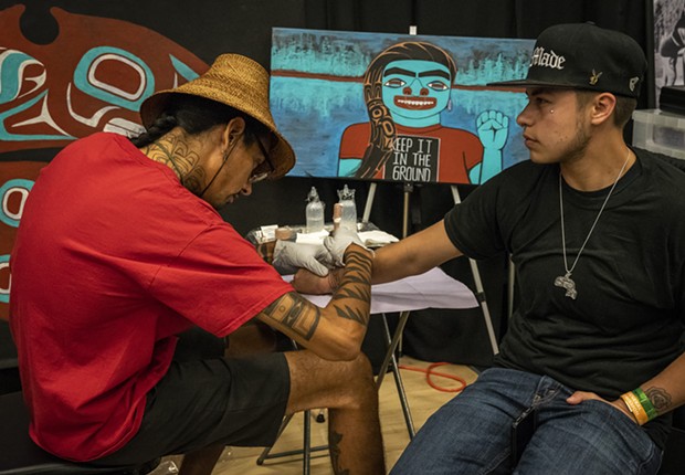 Nahaan (left), of Seattle, focuses on the design style of Northwest Pacific Coast practices, designs and customs of ceremonial tattooing. - PHOTO BY MARK LARSON