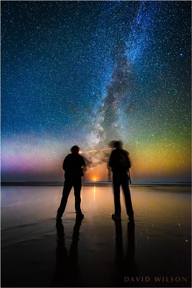The Milky Way rises from just south of due west as the crescent moon sets between two friends at Moonstone Beach on the evening of November 10, 2018. Two months earlier saw the Milky Way rising from a point that would have been nearer the left edge of the photo in relation to the setting moon. By this time of year the Galactic Core has all but disappeared beneath the horizon. - DAVID WILSON