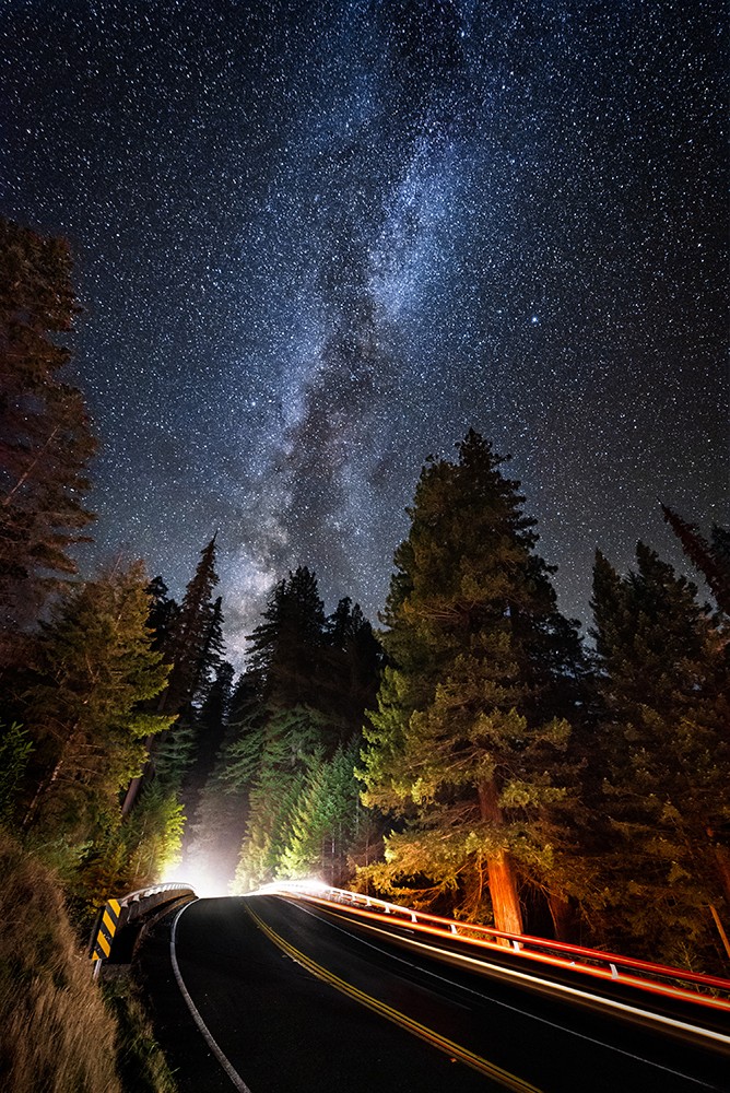 The Avenue of the Giants passes over U.S. Highway 101 beneath the Milky Way at Women's Federation Grove. October of 2018. - PHOTO B Y DAVID WILSON