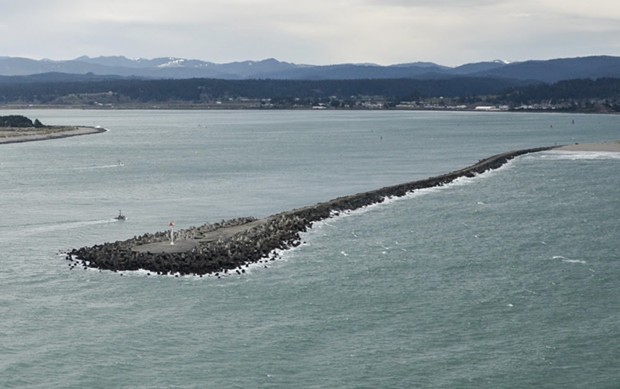 The North Jetty, where a surfer was rescued by an off-duty Coast Guard civilian employee. - USCG