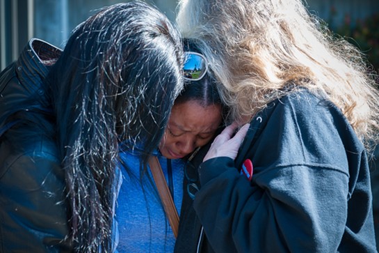 Charmaine Lawson is hugged by supporters shortly before addressing students, faculty and the community on the HSU Quad on the 23-month anniversary of the killing of her son, David Josiah Lawson. - MARK MCKENNA