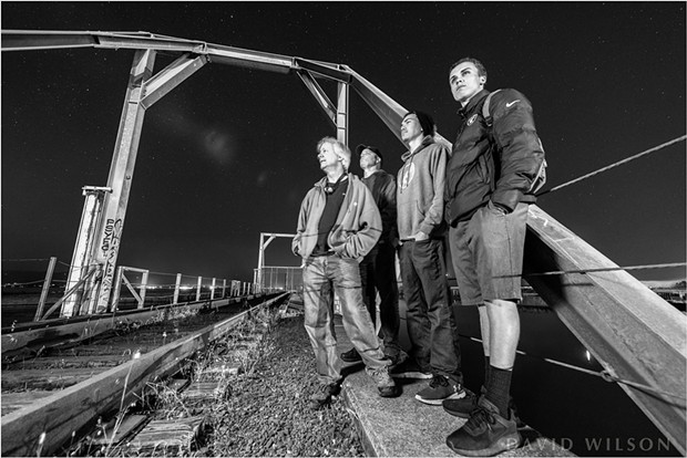 My son, my brother and his son and I wait beside the Eureka Slough railroad tracks. It doesn’t always feel safe out there at night, whether due to thoughts of unfriendly people or ravenous beasts, so I was grateful to have the company of family while photographing. - DAVID WILSON