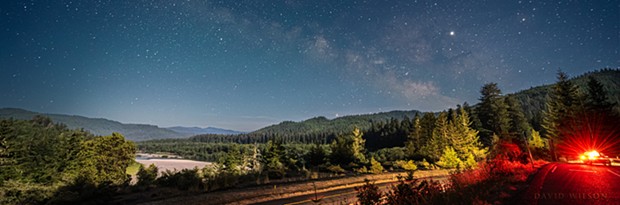 A nighttime view over U.S. Highway 101 and the Eel River Valley beneath the Milky Way as seen from a Vista Point in Humboldt County, California. - DAVID WILSON