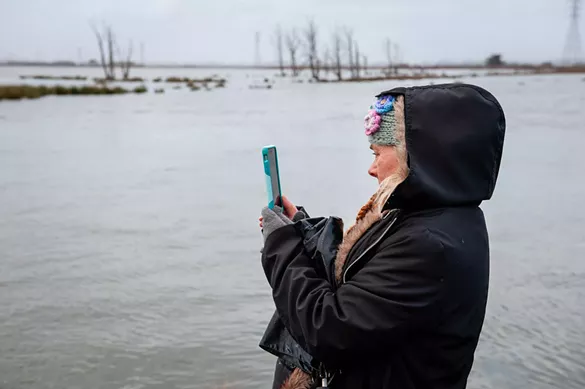 Sherry Van Fossen photographs the King Tide at the Arcata Marsh. - MARK MCKENNA