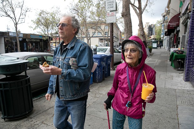 Dolores Helman, 93, and her son Elliot Helman, 64, go for a walk in Berkeley on March 15, 2020, as Gov. Gavin Newsom calls for isolation of all elderly people and those with chronic health conditions in response to growing concern over the coronavirus. - ANNE WERNIKOFF FOR CALMATTERS