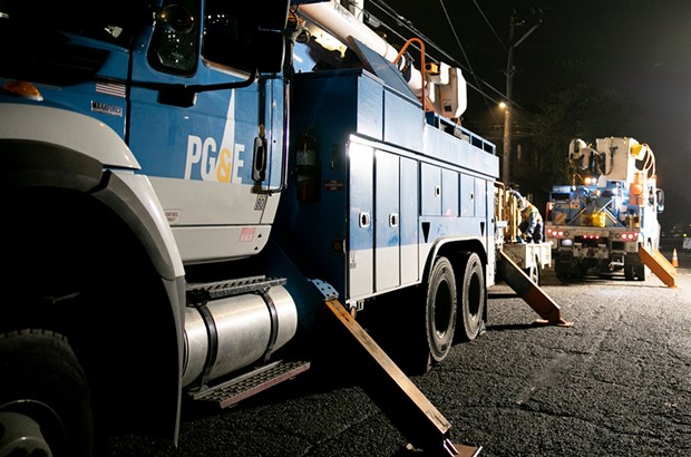 PG&E employees work to replace a nearly 100-year-old utility pole in Berkeley last year. - ANNE WERNIKOFF FOR CALMATTERS