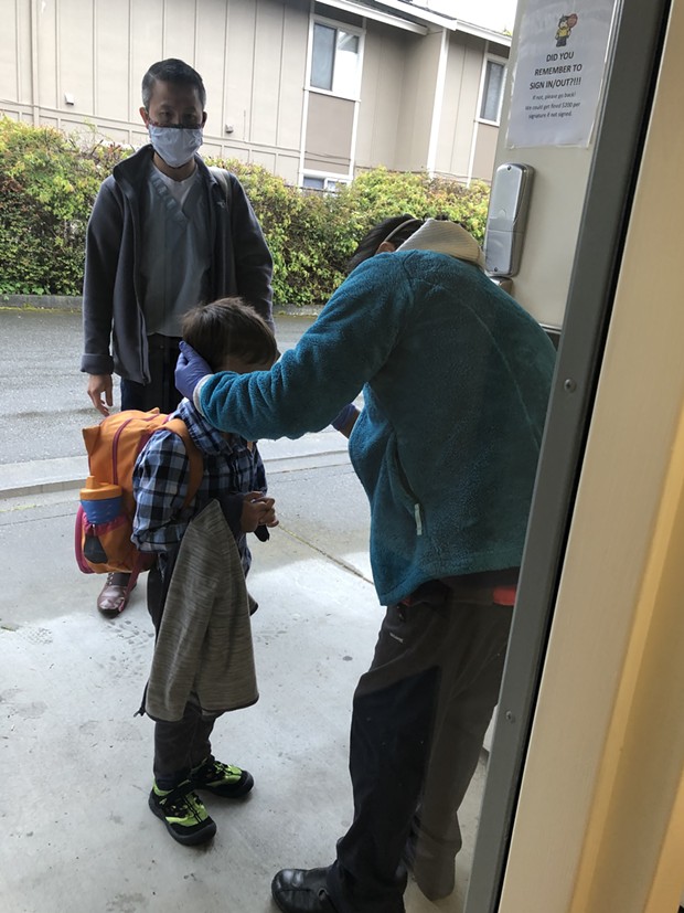 Dr. Kelvin Vu watches as his 5-year-old son Iver is checked in at Little Learners on a recent morning. - COURTESY OF LITTLE LEARNERS
