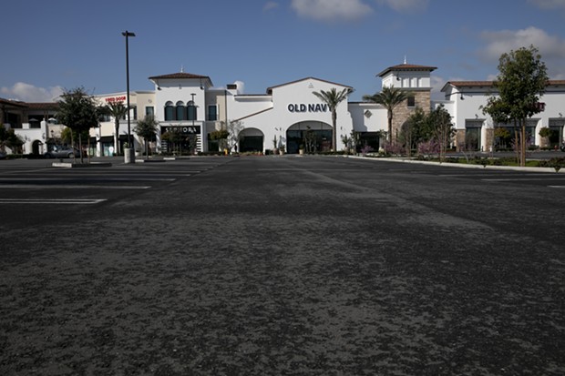 An empty parking lot in front of Old Navy at The Veranda shopping center in Concord on March 19. One third of the center's businesses have been forced to close temporarily due to the shelter in place order in Contra Costa and surrounding counties. - ANNE WERNIKOFF FOR CALMATTERS
