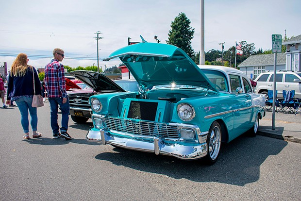 A couple stops to check out Fred Naredo's 1956 Chevy Sedal on July 28 at the Fortuna Redwood AutoXpo. - PHOTO BY MEGAN BENDER