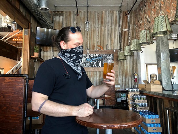 Dylan Powers, 40, assistant brewer, samples a new habanero Pilsner in the bar of Sage Plant Based Bistro. - NIGEL DUARA FOR CALMATTERS