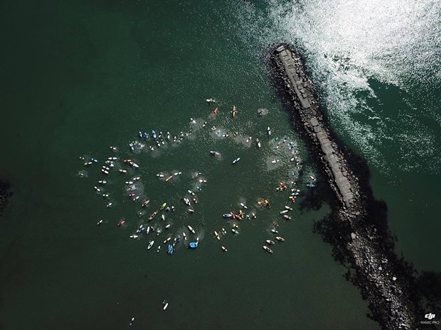 Humboldt surfers, paddle boarders and kayakers perform a ceremonial paddle out for black and brown people killed by police. - ROWDY KELLEY