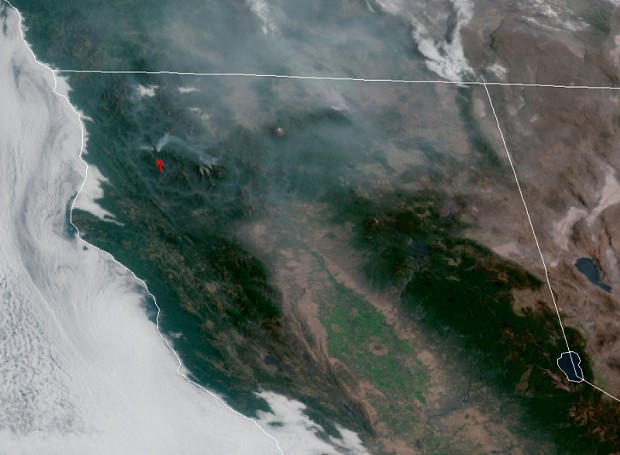 Smoke from the Red Fire and the Salmon Fire are indicated by a red arrow. - IMAGERY FROM THE GOES WEST SATELLITE ON JULY 28