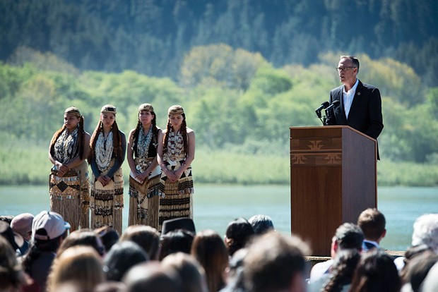 North Coast Congressman Jared Huffman, flanked by Yurok dancers, shortly before the signing of an agreement to remove four hydroelectric dams along the Klamath River in 2016. - MARK MCKENNA