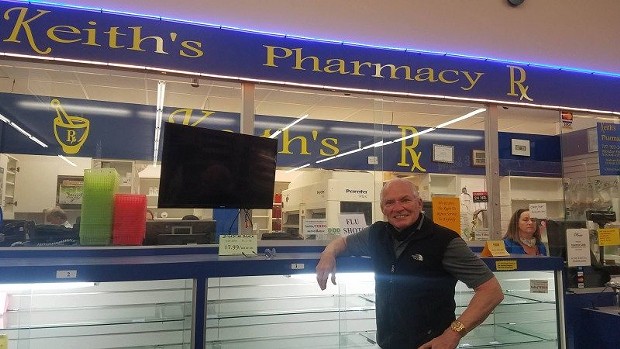Keith Lorang poses in front of empty shelves at his pharmacy which is closing at the end of Friday. - LAUREN SCHMITT, COURTESY OF KMUD