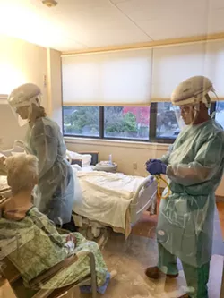 St. Joseph Hospital hospitalist Paul Shen (right) and registered nurse Casey Schuetzle with a patient in the hospital's medical surgical unit. - SUBMITTED