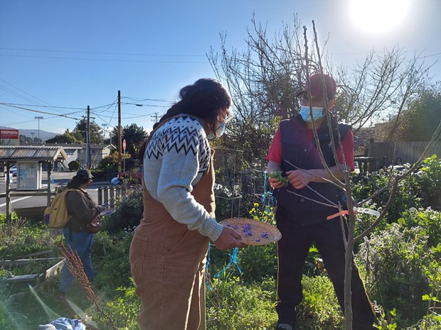 Brenda Perez with Adan Cervantes Perez at a community garden. - CENTRO DEL PUEBLO