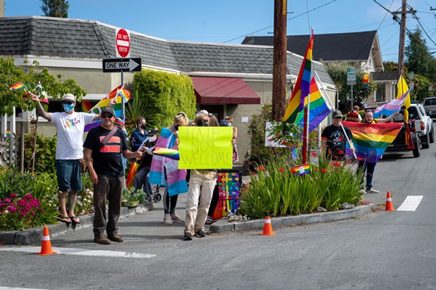 About a dozen people came out to fight hate on the corner of H and 18th streets in Arcata on June 25 after posts on Nextdoor and other social media told of a Pride flag in a garden on the same corner being burned. - PHOTO BY MARK MCKENNA