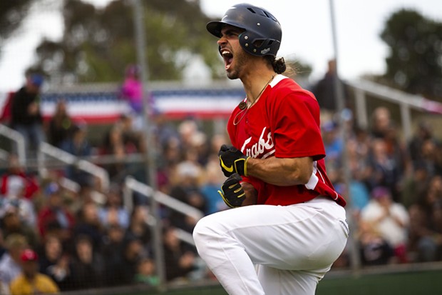 Crabs outfielder Tyler Ganus (No. 34) jumps up and celebrates in front of the crowd after scoring against the visiting Seals Baseball team at Arcata Ballpark on July 9, 2021. - THOMAS LAL