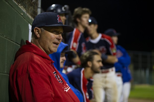 Crabs manager Robin Guiver sits outside of the dugout with his players behind him while the Crabs attempt to rally late against the West Coast Kings on July 17, 2021. - THOMAS LAL