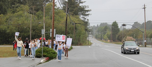 McKinleyville High School students march down Central Avenue after walking out of class in solidarity with victims of sexual assault. - THADEUS GREENSON