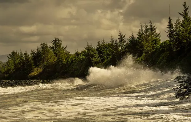 A recent storm surge sent waves overtopping the riprap rock slope protection at Buhne Hill in front of the nuclear waste storage site in King Salmon. - PHOTO BY ALDARON LAIRD