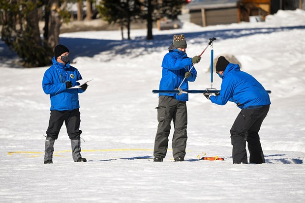 From left, Andy Reising and Anthony Burdock, both Water Resources Engineers in the Snow Surveys and Water Supply Forecasting Unit and Sean de Guzman, right, Manager of the California Department of Water Resources Snow Surveys and Water Supply Forecasting Unit, begin the measurement phase of the second media snow survey of the 2022 season at Phillips Station in the Sierra Nevada Mountains on Feb. 1, 2022. - KENNETH JAMES/CALIFORNIA DEPARTMENT OF WATER RESOURCES