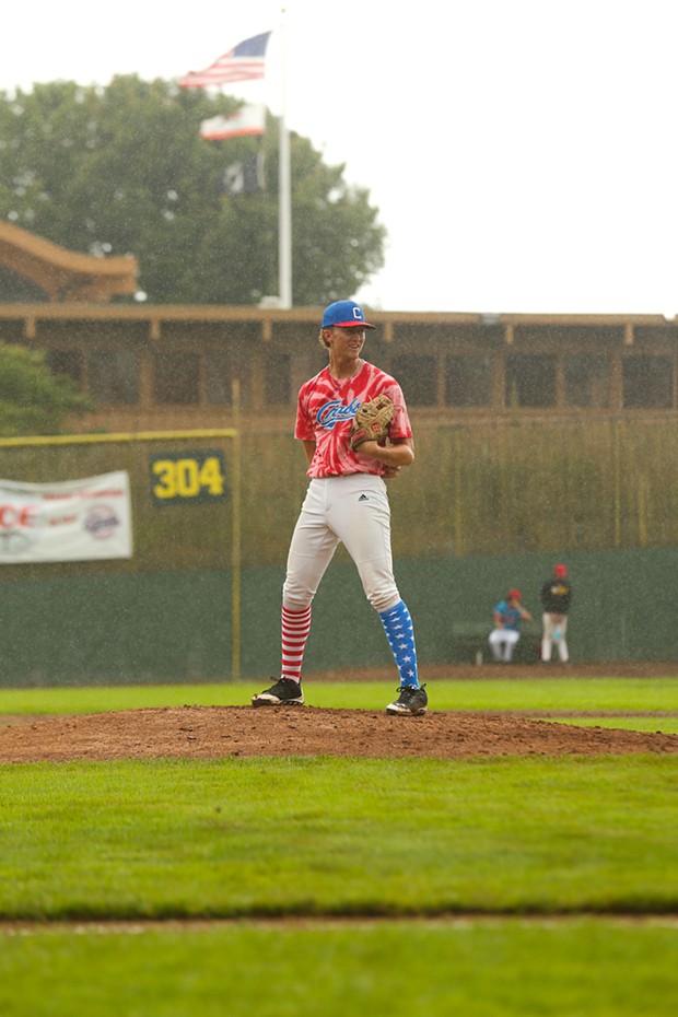 Mckinleyville local and Humboldt Crabs pitcher Cameron Saso stands on the mound as rain falls at Arcata Ballpark on the Fourth of July. - THOMAS LAL