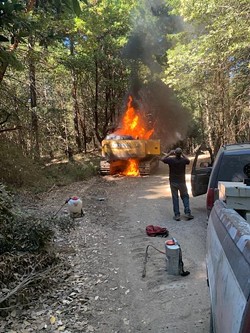 An excavator burns on California State Parks land near a Humboldt Redwood Co. logging operation on Rainbow Ridge. - SUBMITTED