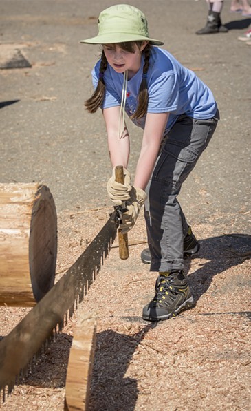 One of the more popular activities was cutting a round with a two-handled saw from "second-growth redwood, obviously!", according to Megan Boyle, 9, Havre, Montana. - MARK LARSON