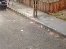 A police photo of the scene of the fatal shooting. Numbered white evidence markers show the locations of where California Department of Justice investigators found seven shell casings from officer Steven Linfoot's gun. - THADEUS GREENSON