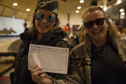 Karen Smith and her daughter holding up their score card from the the LeBOWLski event at the E&O bowling alley. - SAM ARMANINO