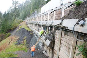 Workers gather data from load sensors on a retaining wall that is at one of the fail points. - PHOTO BY MARK MCKENNA