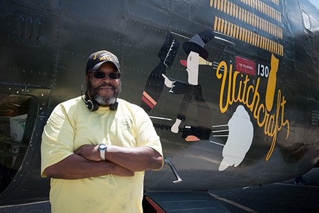 Chef "Grizzly" Adams stands by the 130 bombs painted on the side of the Witchcraft — one for every successful mission. - PHOTO BY MARK MCKENNA
