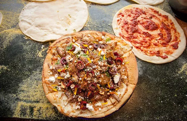 Duck confit salad pizza with chèvre. - AMY KUMLER