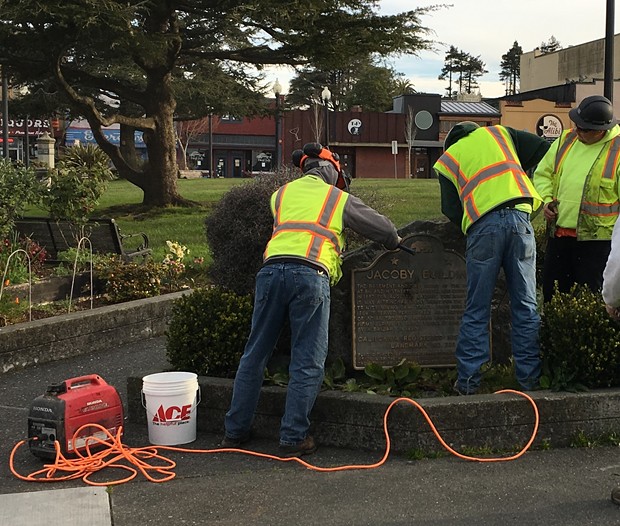 City workers loosen the 1963 marker. - COURTESY OF THE CITY OF ARCATA